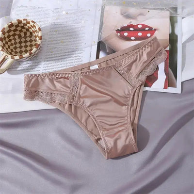 Single nude satin bikini panty with scalloped lace trim laid flat on a gray surface