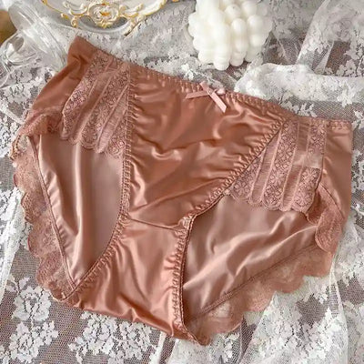 Dusty rose mauve satin panties with lace panel detail and scalloped leg trim, lace backdrop
