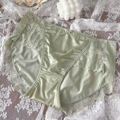 Sage green satin lace panel panties with scalloped trim and center bow, laid on lace