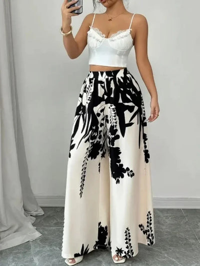 Full-length mirror selfie showing ivory floral wide-leg pants styled with white lace crop top
