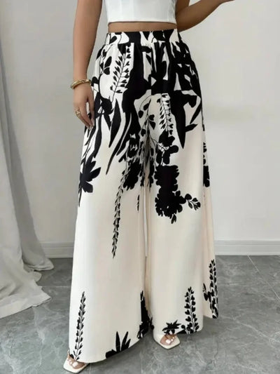 Front view of floor-length ivory pants with black botanical print and wide fluid leg