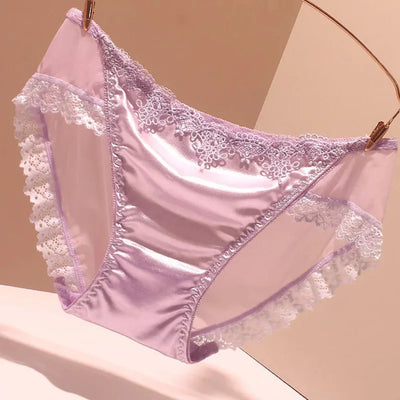 Lavender satin panties with white floral lace trim hanging on gold clips