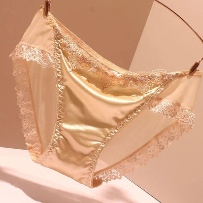 Champagne satin bikini panties with tonal lace trim on pink background