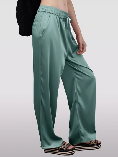 Side profile of teal satin wide-leg pants showing fluid drape and full length