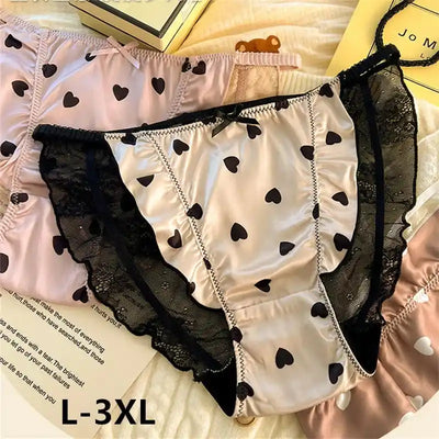 White satin panties with black heart print and black ruffled lace trim flat lay