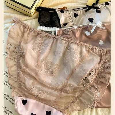 Sheer floral lace panties in nude tone with ruffled hem and pink satin pair beside