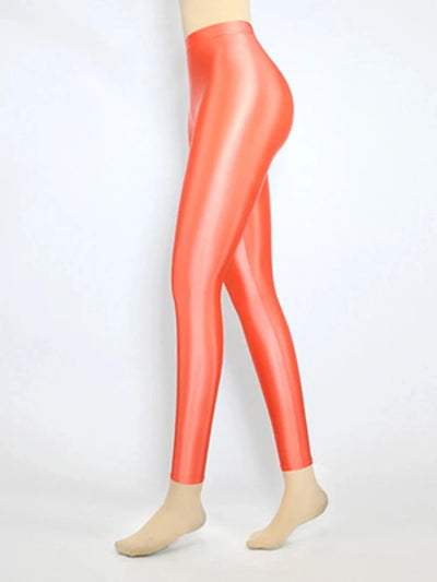 Side view of glossy high-rise orange-red tapered satin pants on mannequin