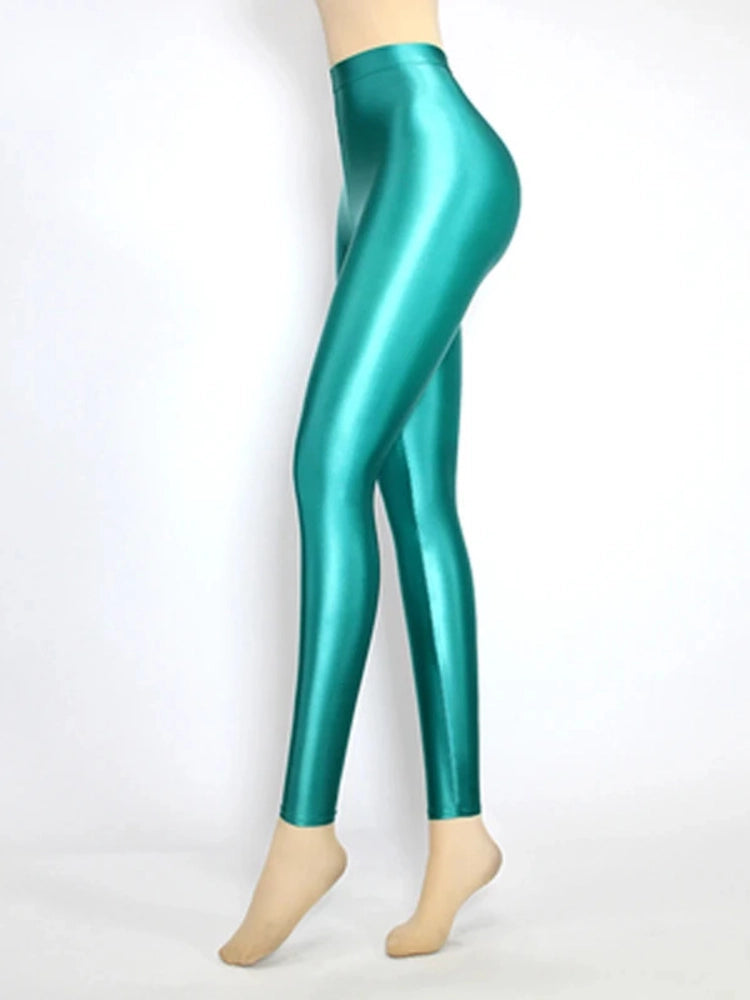 Side view of glossy high-rise emerald green tapered satin pants on mannequin