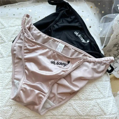 Blush pink and black low-rise satin bikini briefs with embroidered front panel detail