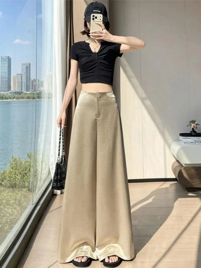 Full-length view of woman wearing champagne wide-leg floor-length pants with black crop top