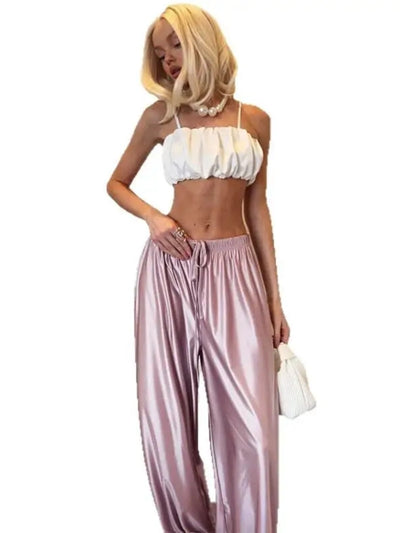 Full outfit view of mauve wide-leg satin pants with white crop top and strappy heeled sandals on white background