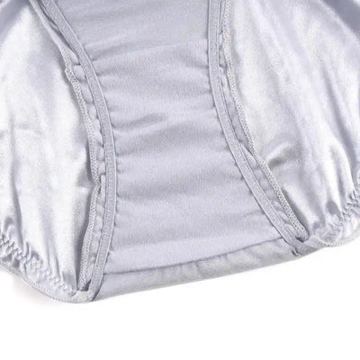 Close-up of silver gray satin panty interior showing gathered crotch seam stitching detail