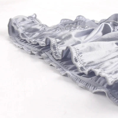 Close-up of silver gray satin ruffled waistband edge showing gathered elastic detail
