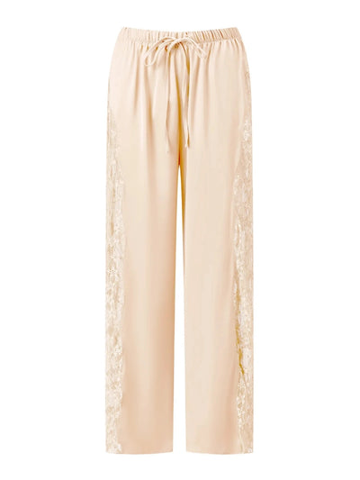 Flat lay of ivory wide-leg pants showing full-length sheer lace side panels and scalloped hem