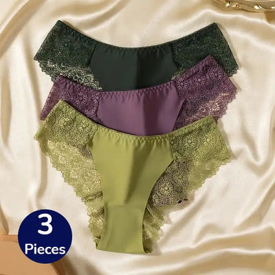 Flat lay of three lace-side bikini panties in dark green, purple, and sage green
