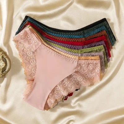Flat lay of multiple lace-trim bikini panties fanned out in assorted colors on satin