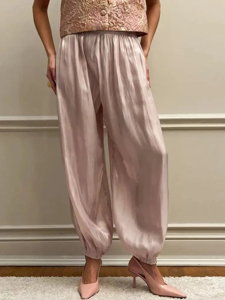 Blush high-shine satin balloon jogger pants with gathered ankle cuffs worn with blush heels