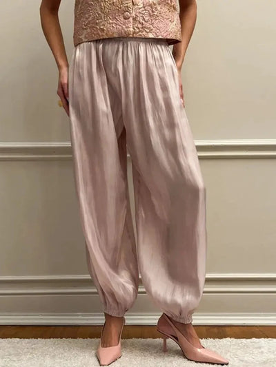 Blush high-shine satin balloon jogger pants with gathered ankle cuffs worn with blush heels