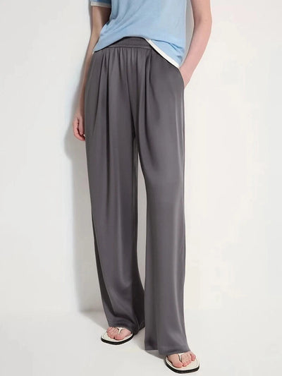 Gray wide-leg satin pants with elastic waist styled with a blue tee and white sandals