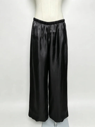 Front flat lay of black wide-leg satin pants with elastic waistband on dress form