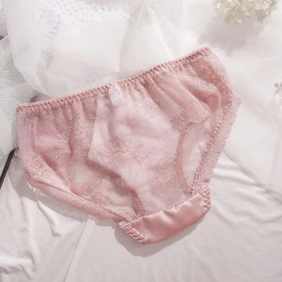 Back view of pink lace panties with satin trim edge on white bedding