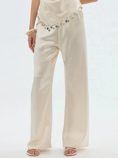 Front view of champagne satin straight-leg pants with elastic waist and wide-leg silhouette