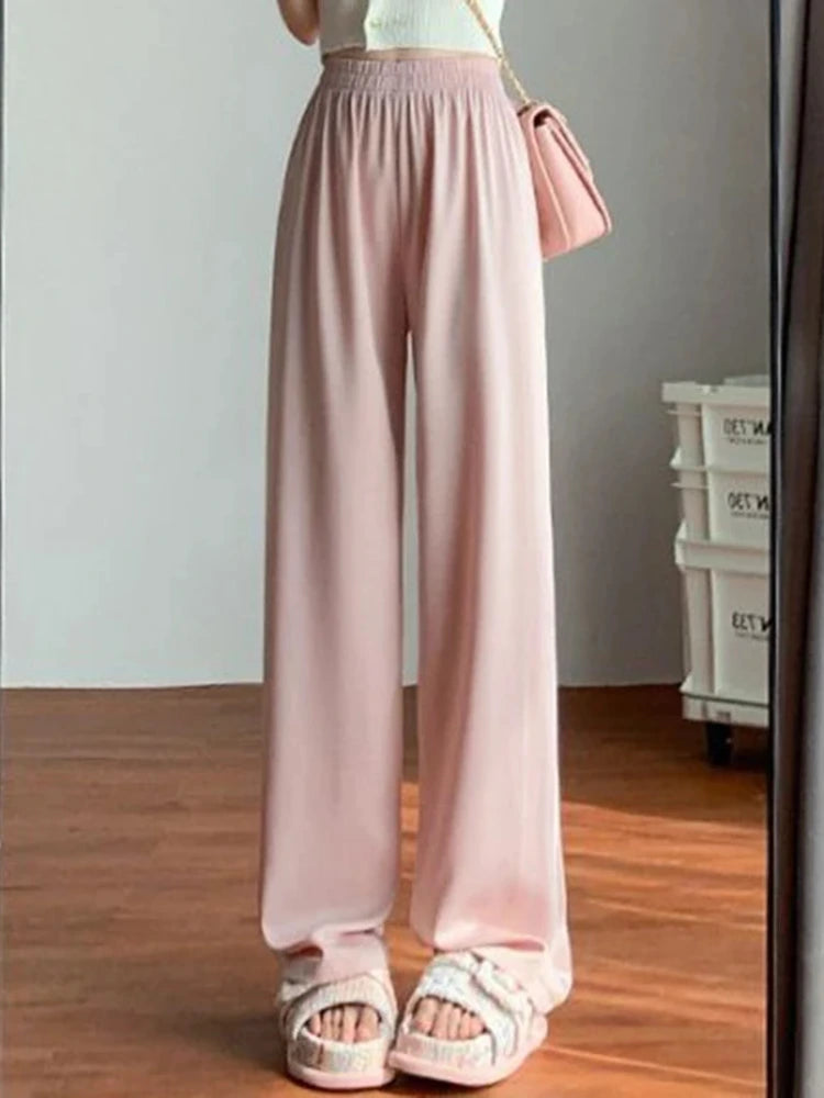 Blush wide-leg satin pants with smocked high waist worn with white top and sandals