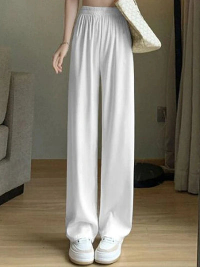 White wide-leg high-waist satin pants with smocked waistband worn with white sneakers