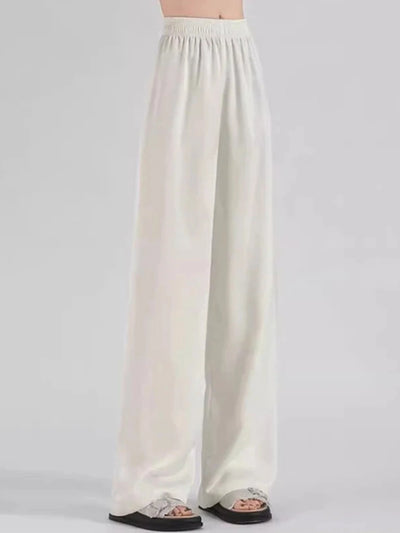 Side view of white floor-length wide-leg pants with smocked elastic high waist