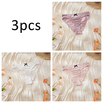 Three-pack satin ruched panties in lavender, white, and light pink individual flat lay shots on cream background
