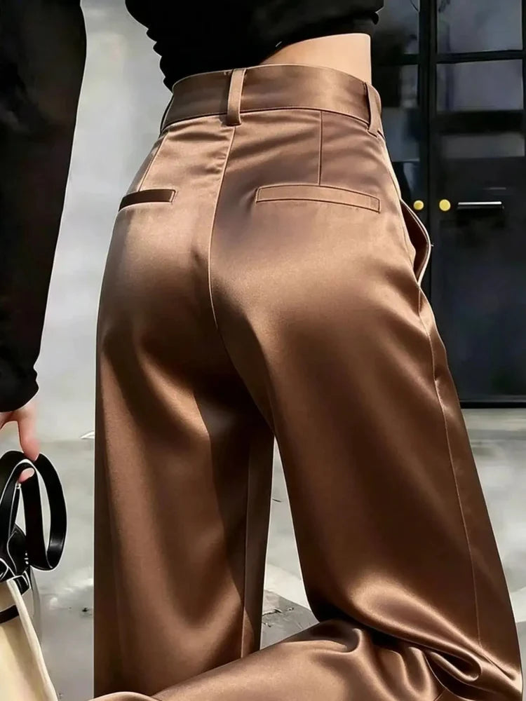 Back view of high-rise chocolate wide-leg satin pants with tailored waistband and welt pocket