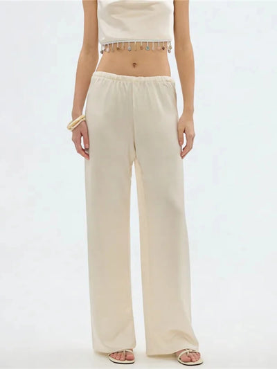 Front view of champagne wide-leg pants with elasticated waistband on female model, white background