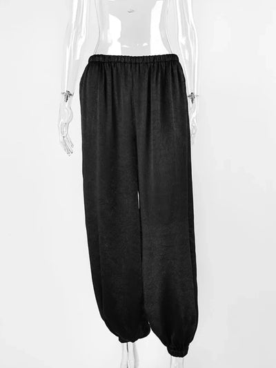 Flat mannequin display of black balloon-leg pants showing full silhouette and elastic waistband