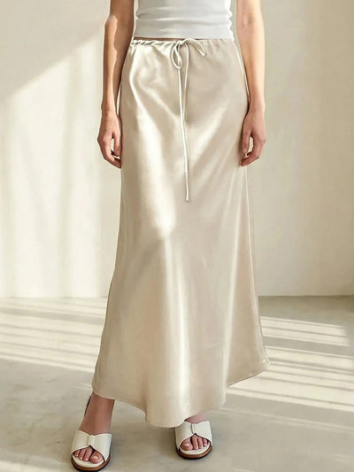 Champagne satin midi skirt with drawstring waist, white tank top, white slide sandals