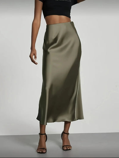 Front view of olive satin high-waist midi skirt paired with black crop top and heeled sandals