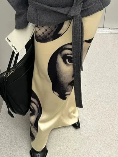 Close-up of Fornasetti-style portrait print on ivory satin mermaid skirt, elevator mirror reflection