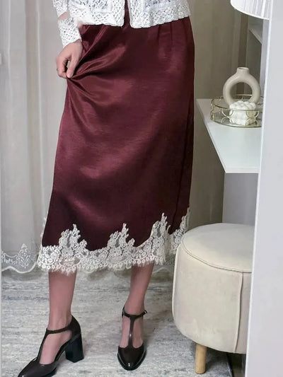 Burgundy satin midi skirt with white lace trim hem styled with white lace top and block heels