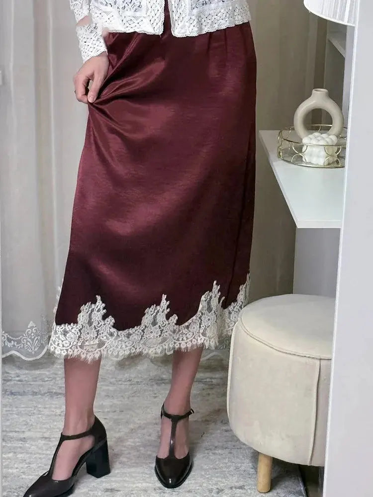 Black velvet midi skirt with ivory floral lace hem worn with white knit sweater and black heels