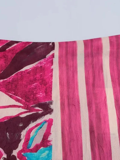 Close-up of glossy pink and cream stripe fabric panel on a floral midi skirt