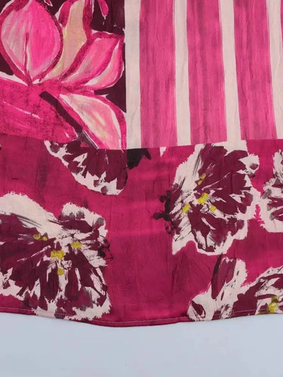 Close-up of brushstroke floral hem border on a deep magenta midi skirt
