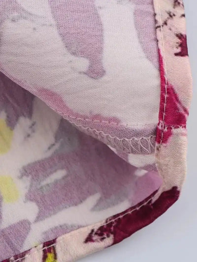 Interior lining detail of a floral midi skirt showing printed underlayer and hem stitching