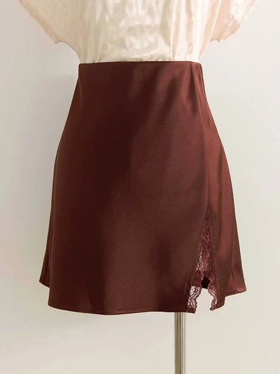 Burgundy satin mini skirt with tonal scalloped lace front split displayed on a garment stand with cream blouse