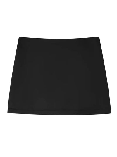 Flat lay of black low-rise satin mini skirt on white background