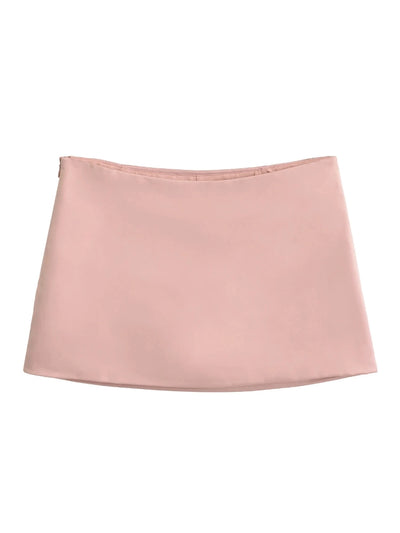 Flat lay of pink low-rise satin mini skirt on white background