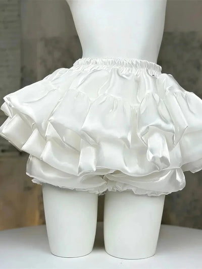 Back view of white tiered bubble satin skirt with bloomer hem on a mannequin