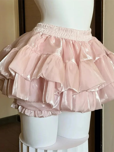 Pink high-shine tiered ruffle bubble satin skirt with gathered layers on mannequin