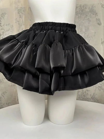 Black satin tiered ruffle bubble skirt with three gathered layers on a mannequin