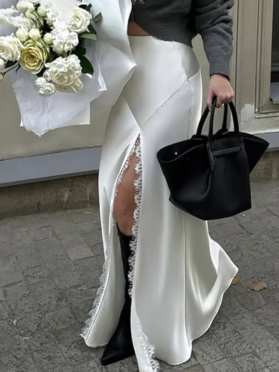 Front view of white satin mermaid skirt showing lace slit detail and frayed trim