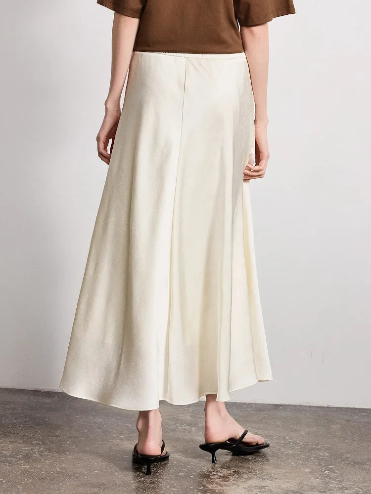 Side view of ivory crinkled satin A-line midi skirt with high waistband and black sandals