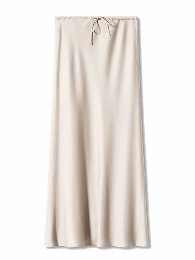 Flat lay of a cream satin maxi skirt with gathered drawstring waistband on white background
